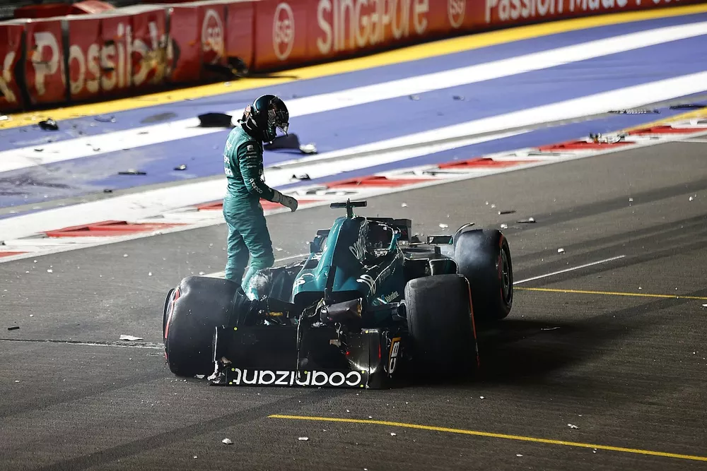 Lance Stroll, Aston Martin AMR23, climbs out of his heavily damaged car after a crash towards the end of Q1