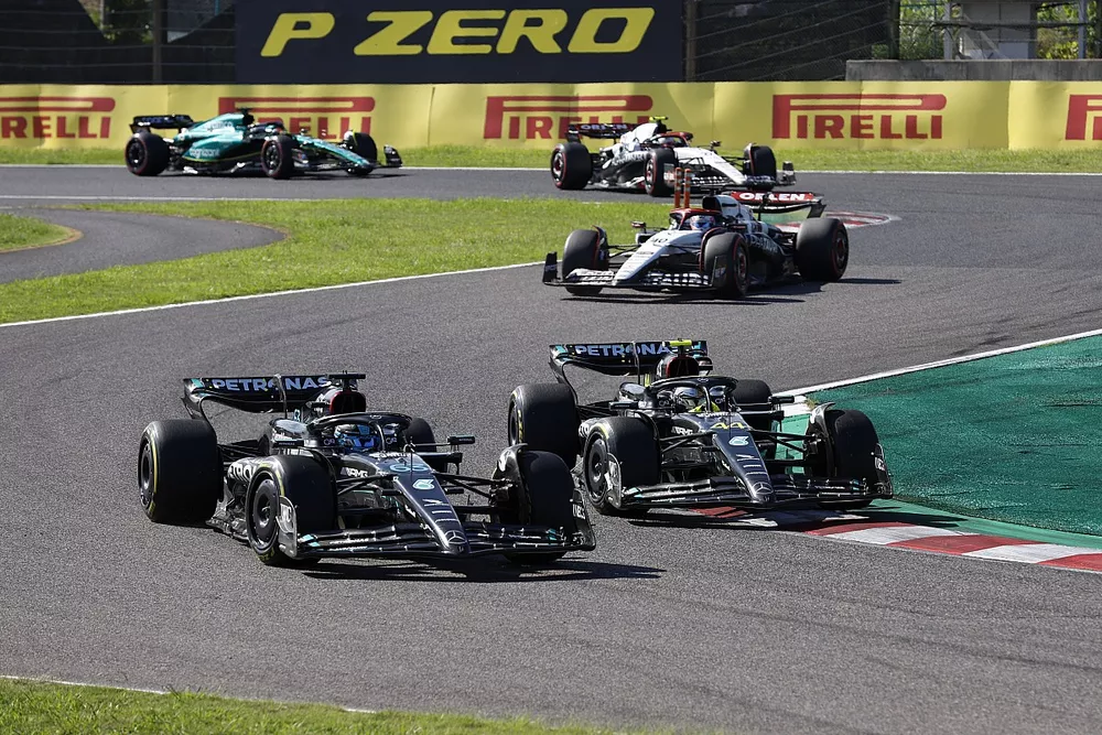 George Russell, Mercedes F1 W14, leads Sir Lewis Hamilton, Mercedes F1 W14, and Liam Lawson, AlphaTauri AT04