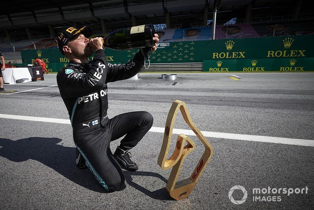 Valtteri Bottas, Mercedes AMG F1, celebrates with his trophy and champagne after the race