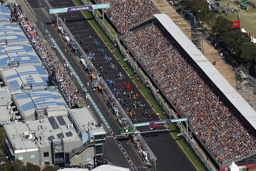 Mechanics on the grid with the cars prior to the start