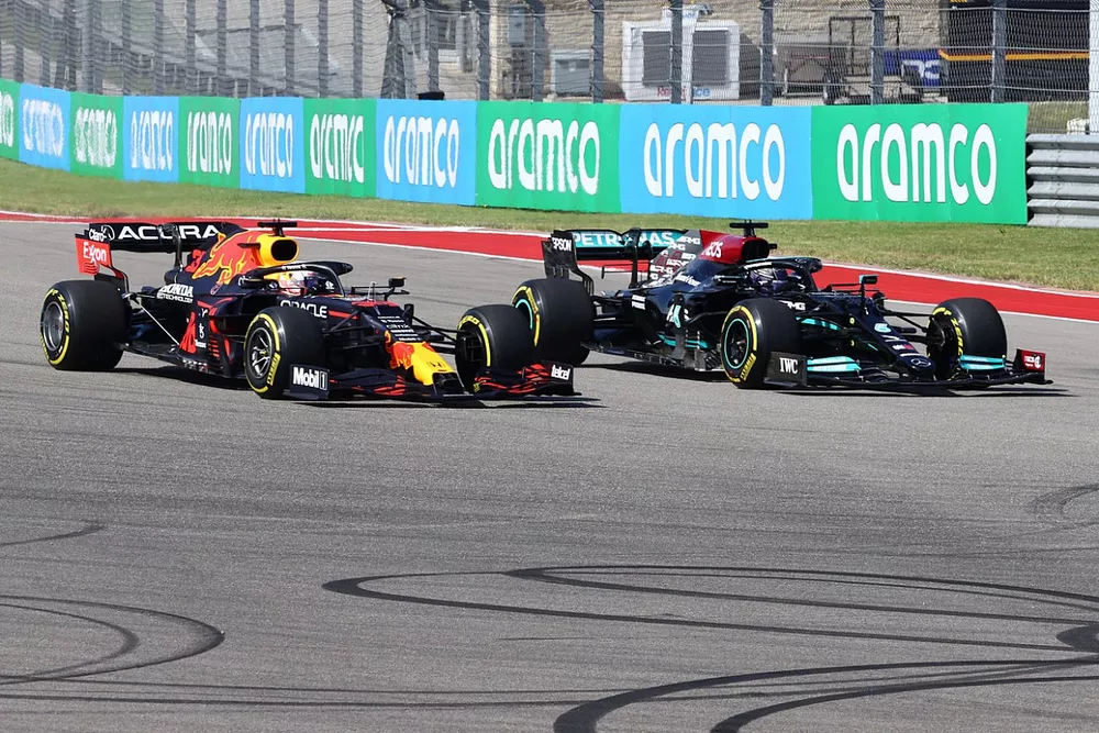 Max Verstappen, Red Bull Racing RB16B, battles with Lewis Hamilton, Mercedes W12, at the start
