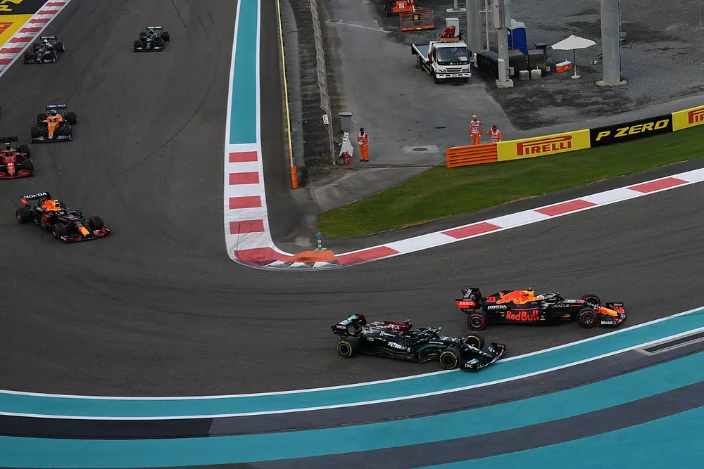 Max Verstappen, Red Bull Racing RB16B, battles with Lewis Hamilton, Mercedes W12, on the opening lap