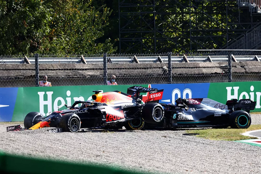 Max Verstappen, Red Bull Racing RB16B, and Lewis Hamilton, Mercedes W12, collide whilst battling for position