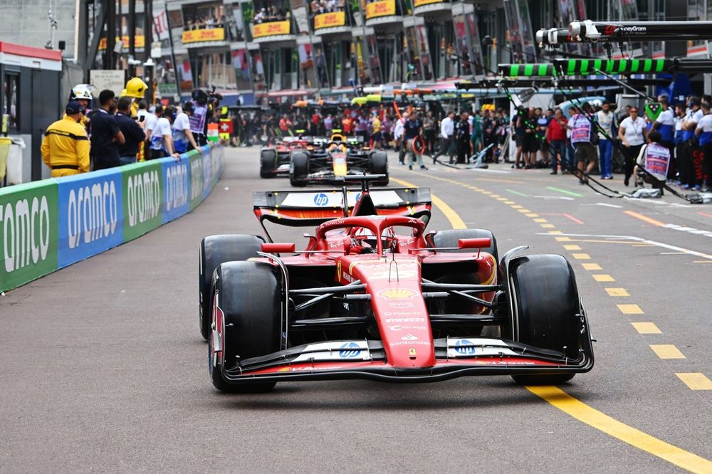 Charles Leclerc, Ferrari SF-24, Sergio Perez, Red Bull Racing RB20, in the pit lane