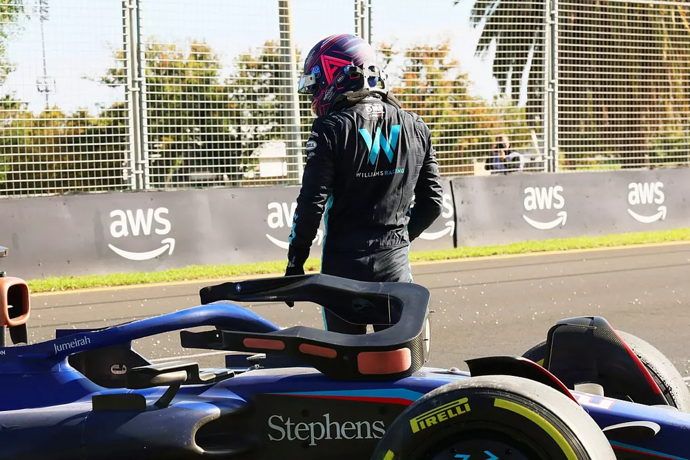 Alex Albon, Williams FW45, climbs from his car after a crash