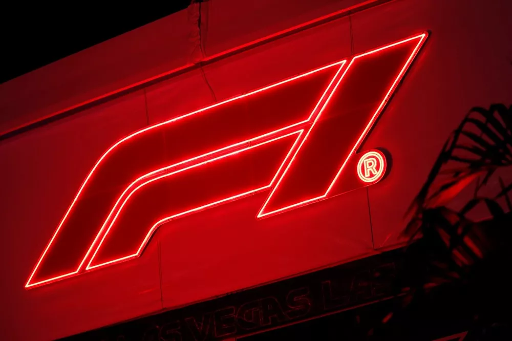 The F1 logo lit up at night in the paddock