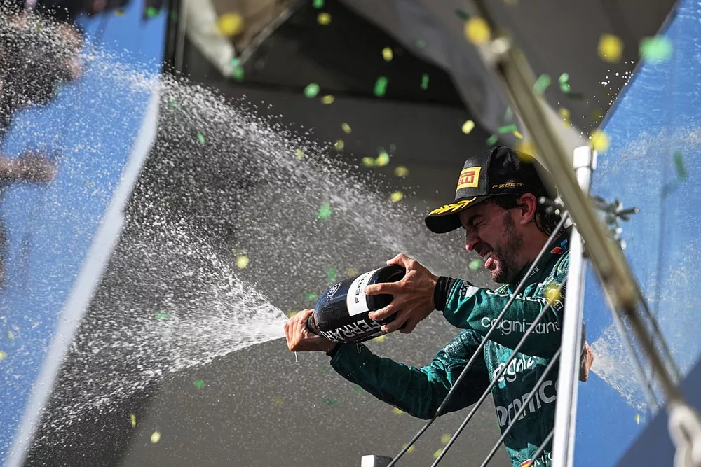 Fernando Alonso, Aston Martin F1 Team, 3rd position, sprays Champagne from the podium