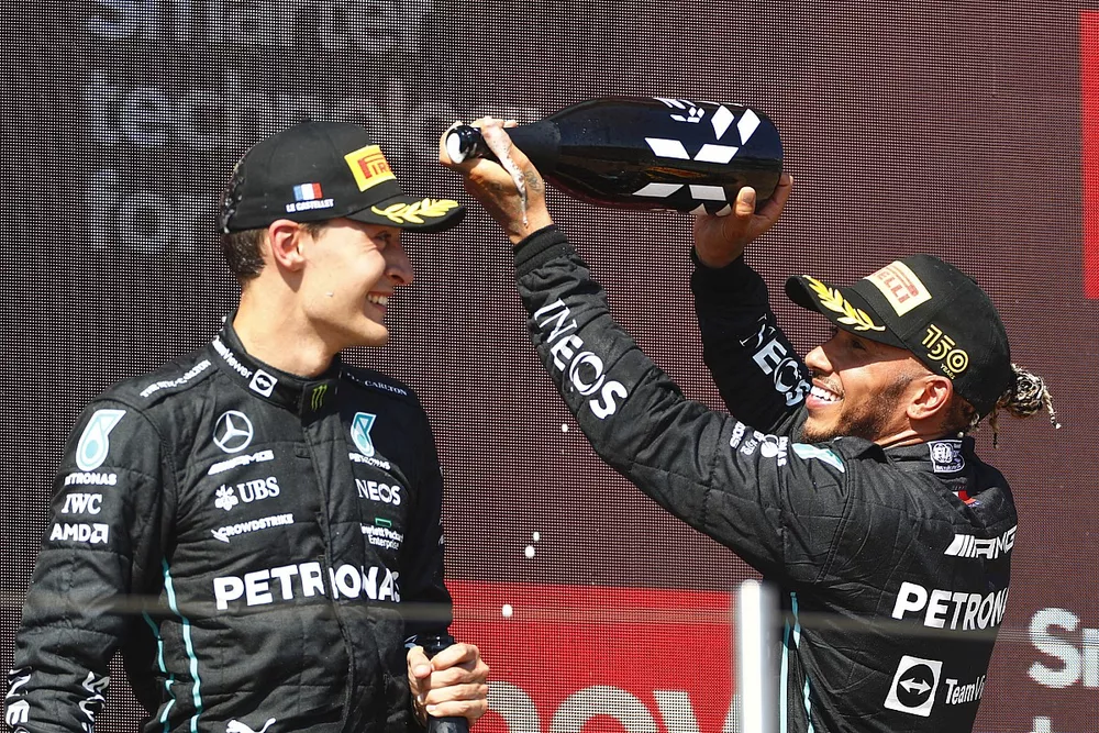 Lewis Hamilton, Mercedes-AMG, 2nd position, sprays George Russell, Mercedes-AMG, 3rd position, with Champagne on the podium