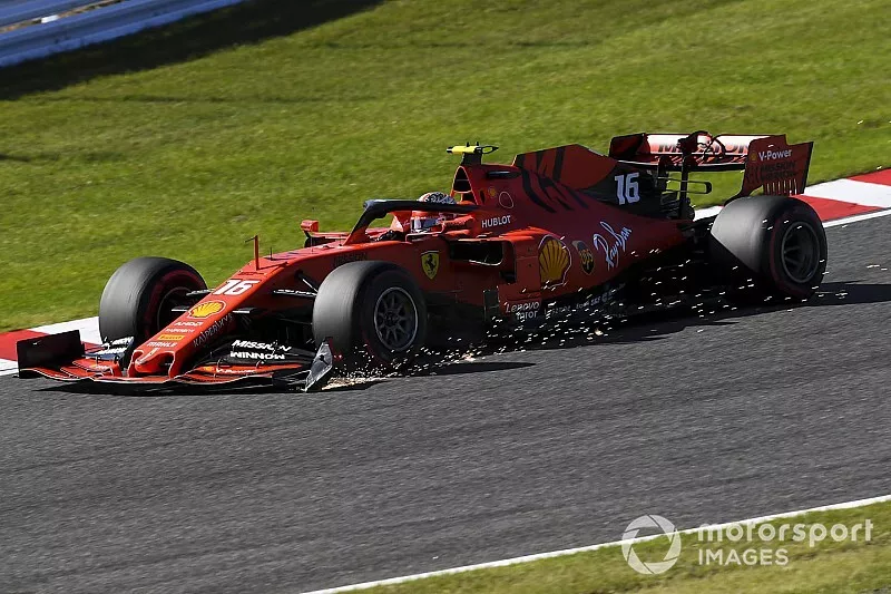 Charles Leclerc, Ferrari SF90, trails sparks from his damaged front wing after contact with Max Verstappen, Red Bull Racing RB15, on the opening lap