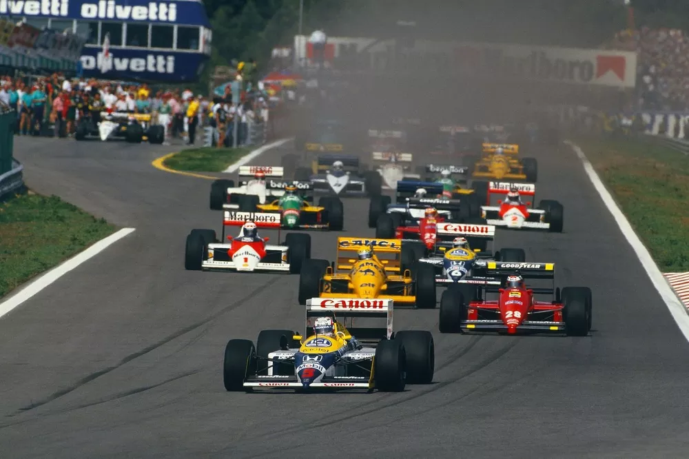 Nigel Mansell, Williams FW11B Honda, leads Gerhard Berger, Ferrari F187, Ayrton Senna, Lotus 99T Honda