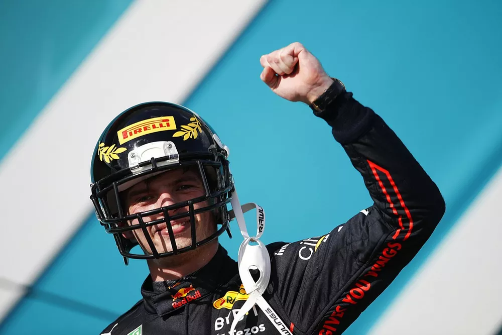 Max Verstappen, Red Bull Racing, 1st position, arrives on the podium wearing a celebratory Pirelli American Football Helmet