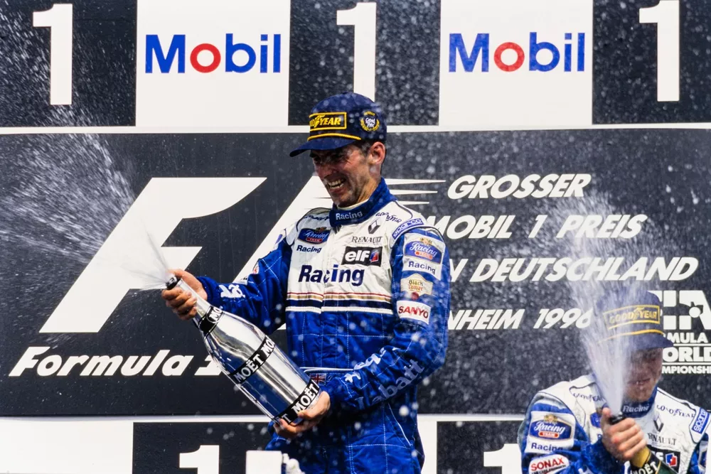 Damon Hill, Williams, 1st position, and Jacques Villeneuve, Williams, 3rd position, celebrate on the podium