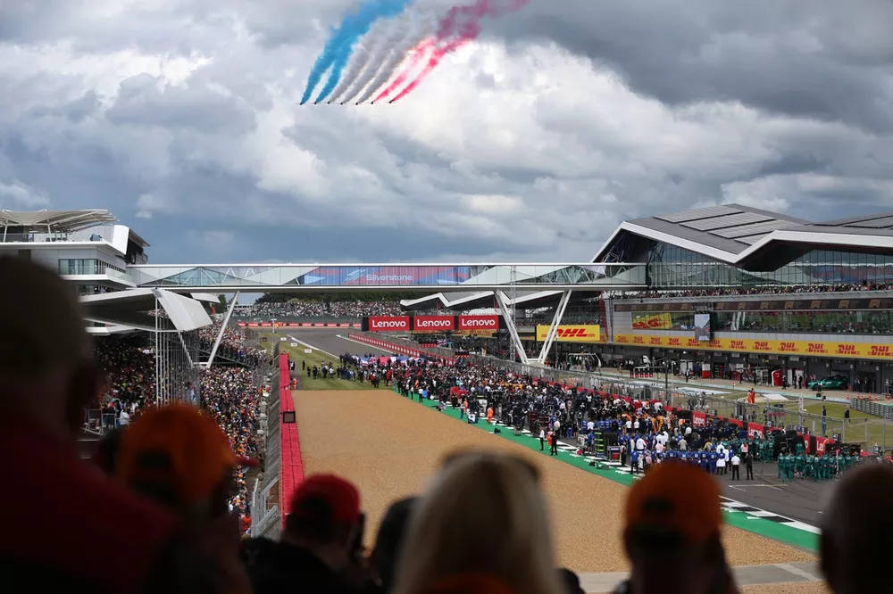 The Red Arrows fly over the grid at Silverstone