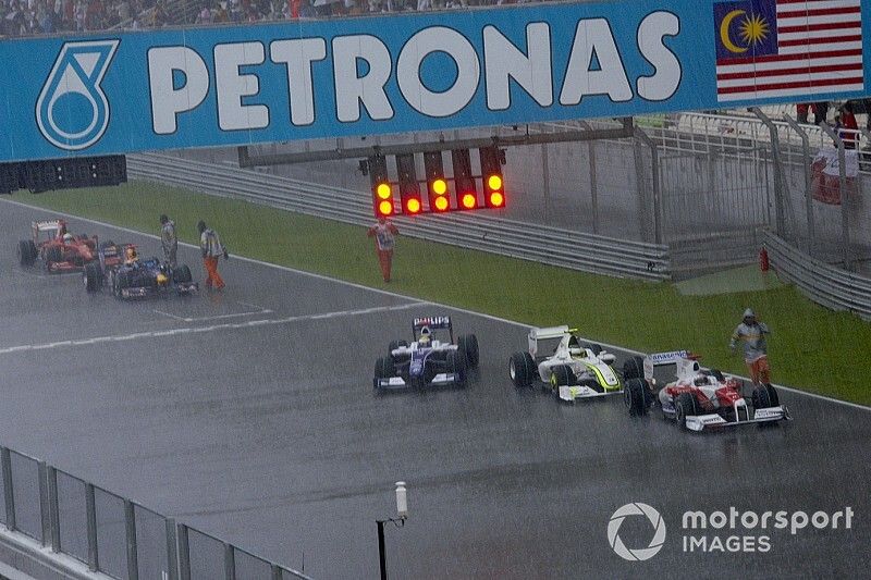 Los coches se detienen en la recta principal, ya que la carrera tiene bandera roja en la vuelta 33 debido a las condiciones meteorológicas