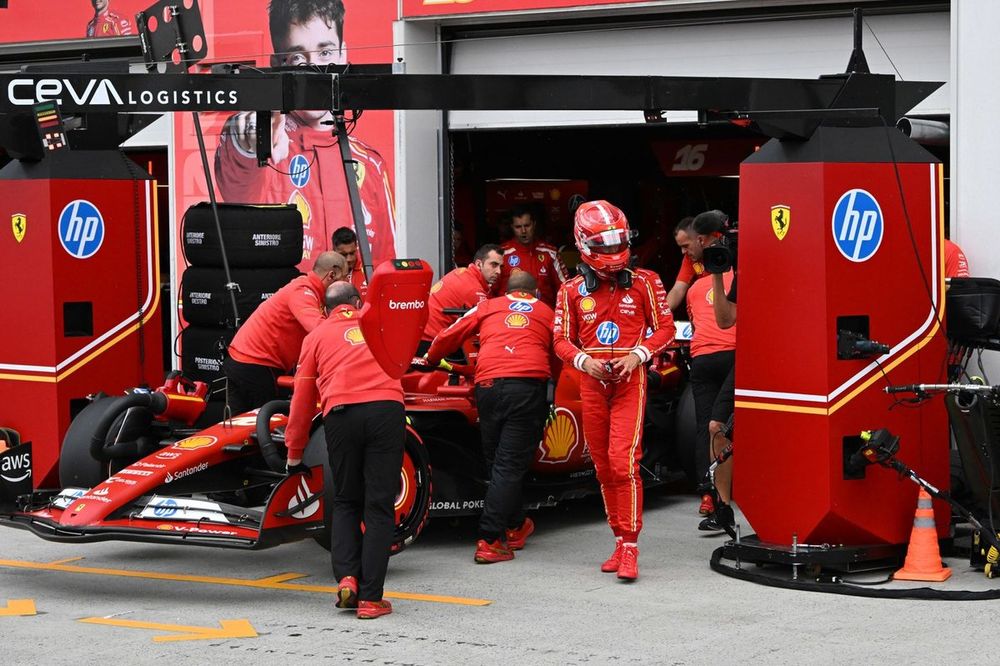 Charles Leclerc, Scuderia Ferrari, walks down the pit lane