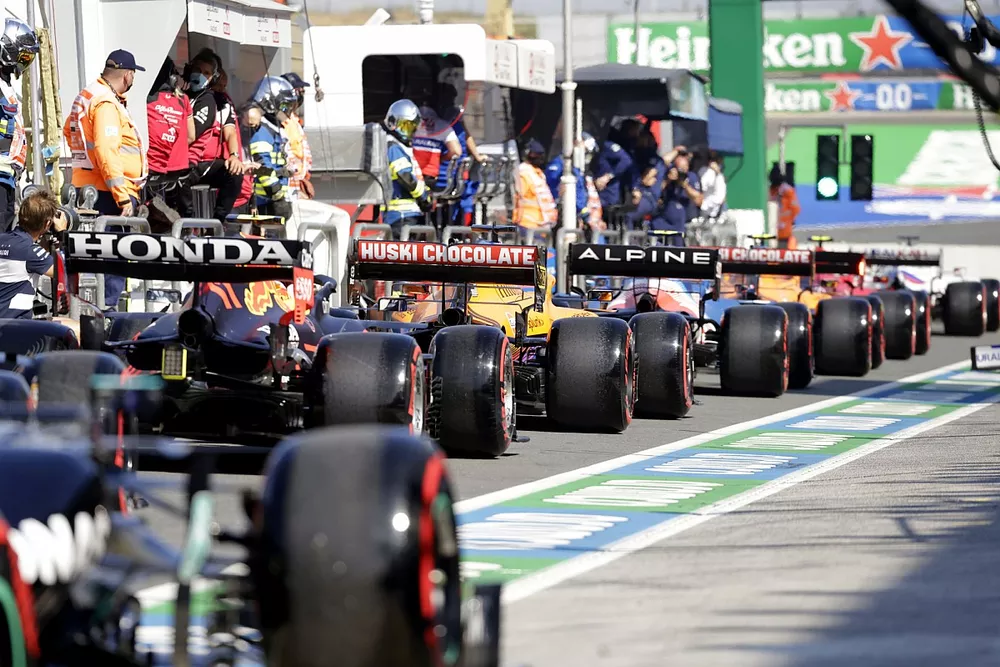 The drivers queue to leave the pit lane
