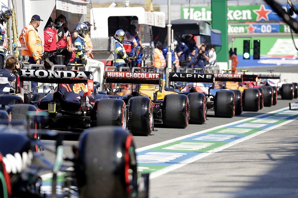 The drivers queue to leave the pit lane