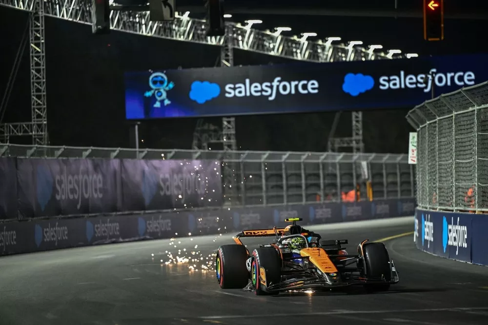 Lando Norris, McLaren MCL38, kicks up sparks