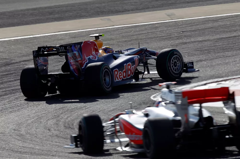 Mark Webber, Red Bull Racing RB6 Renault, 8th position, leads Jenson Button, McLaren MP4-25 Mercedes, 7th position.