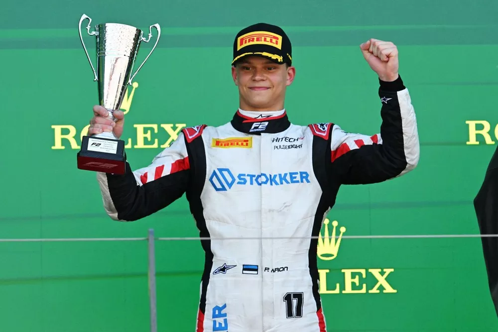 Paul Aron, Hitech Pulse-Eight, 2nd position, lifts the trophy in celebration 