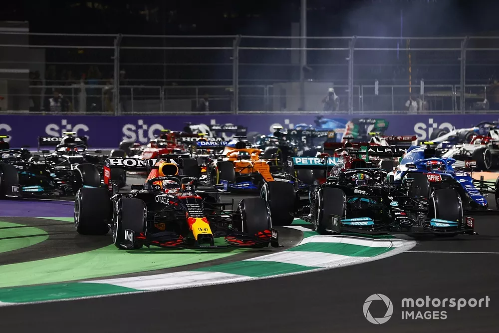 Max Verstappen, Red Bull Racing RB16B, runs off the track while battling with Lewis Hamilton, Mercedes W12 at the restart