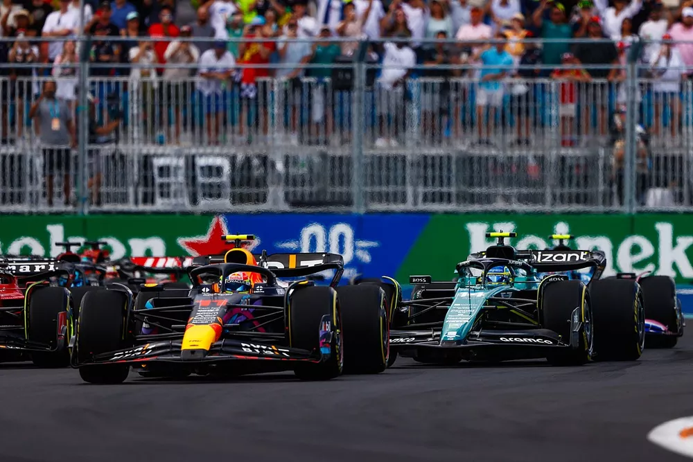 Sergio Perez, Red Bull Racing RB19, Fernando Alonso, Aston Martin AMR23, the rest of the field on the opening lap