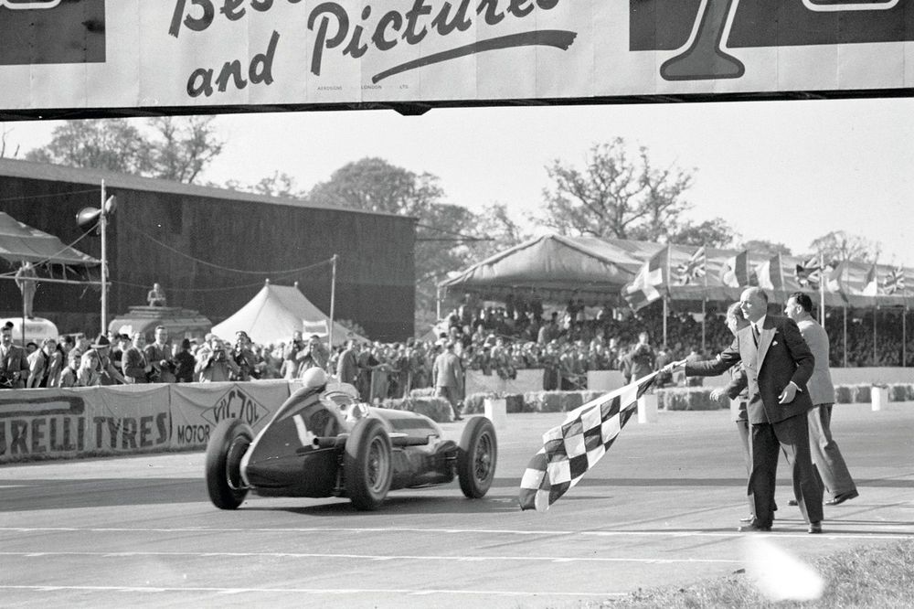 Reg Parnell, Alfa Romeo 158, takes the chequered flag for the final podium position