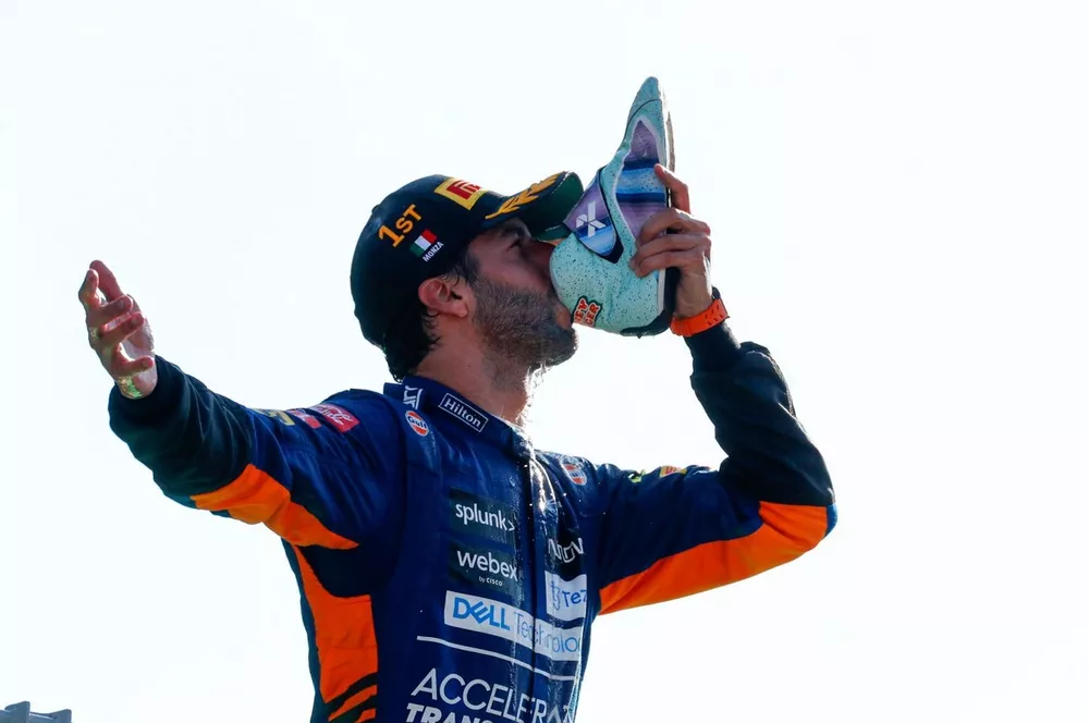 Daniel Ricciardo, McLaren, 1st position, performs a shoey on the podium