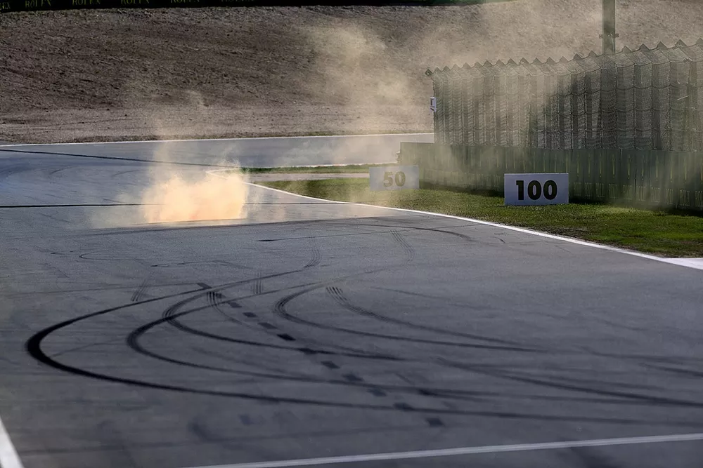 Smoke from a flare thrown on to the circuit

