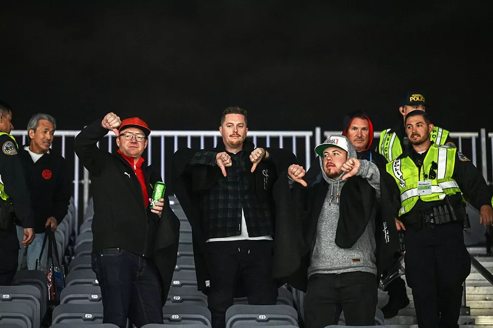 Police eject fans from a grandstand