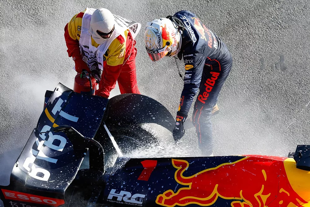 Max Verstappen, Red Bull Racing, retires from the race and a marshal assists with a fire