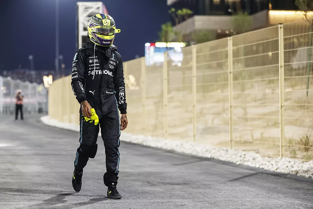 Lewis Hamilton, Mercedes-AMG, walks back after retiring from the race
