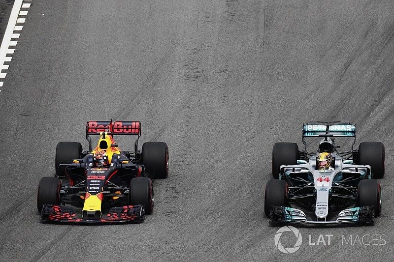 Max Verstappen, Red Bull Racing RB13, passes Lewis Hamilton, Mercedes AMG F1 W08, for the lead