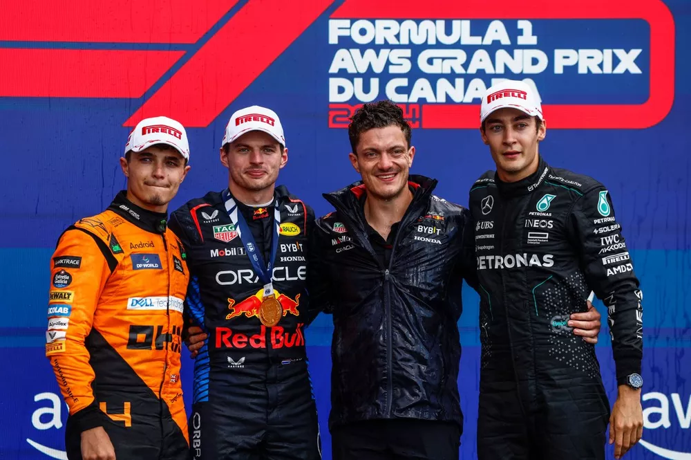 Lando Norris, McLaren F1 Team, 2nd position, Max Verstappen, Red Bull Racing, 1st position, the Red Bull trophy delegate and George Russell, Mercedes-AMG F1 Team, 3rd position, on the podium