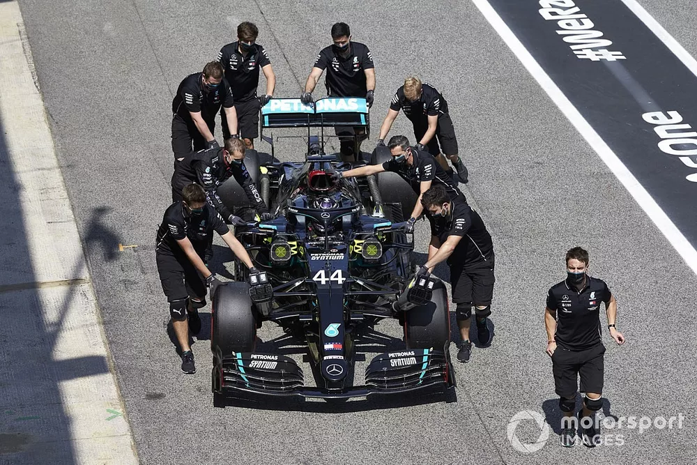 Mechanics assist Lewis Hamilton, Mercedes F1 W11 , in Parc Ferme