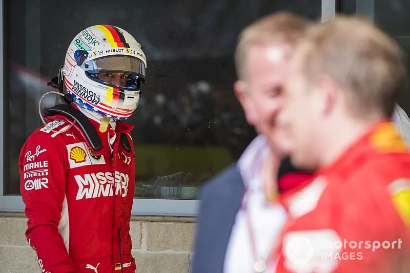 Sebastian Vettel, Ferrari, looks over as Kimi Raikkonen, Ferrari, 1st position, is interviewed by Martin Brundle, Sky Sports F1.