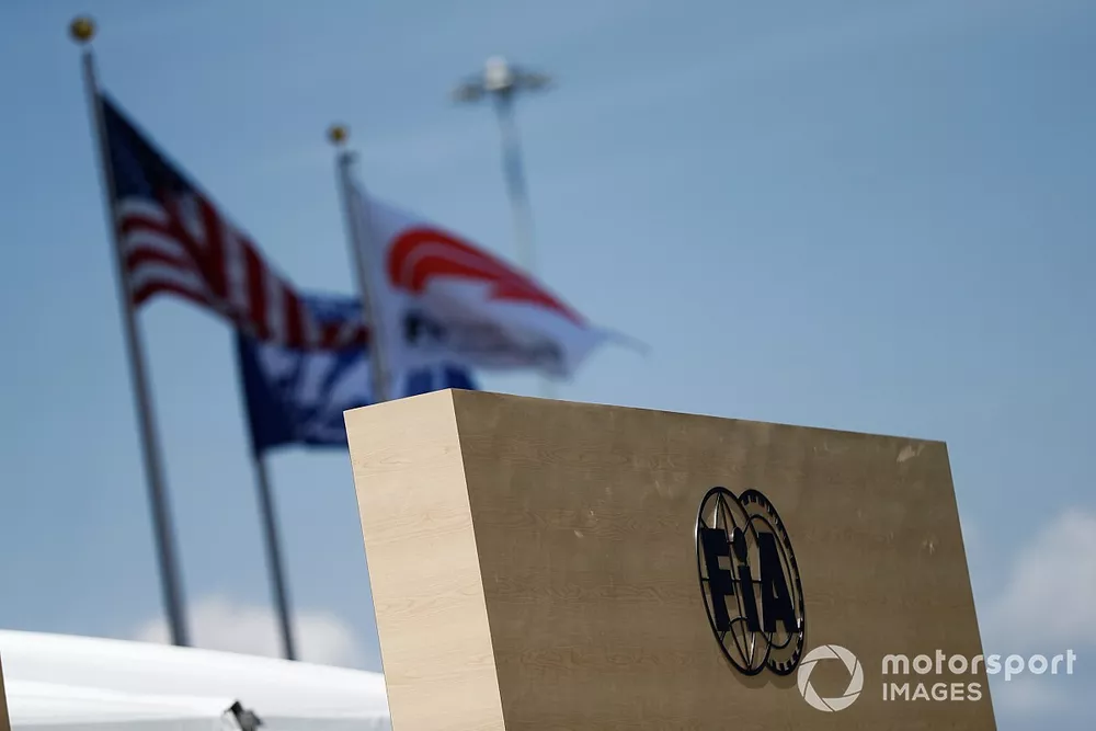 The FIA logo in front of an American flag