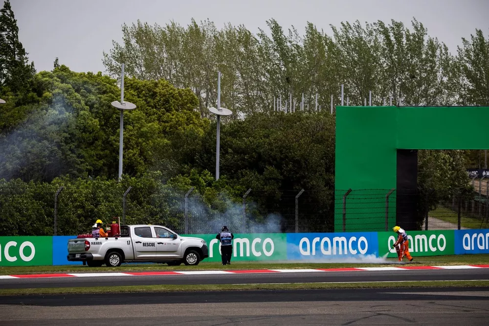Marshals rush to put out the fire on the grass