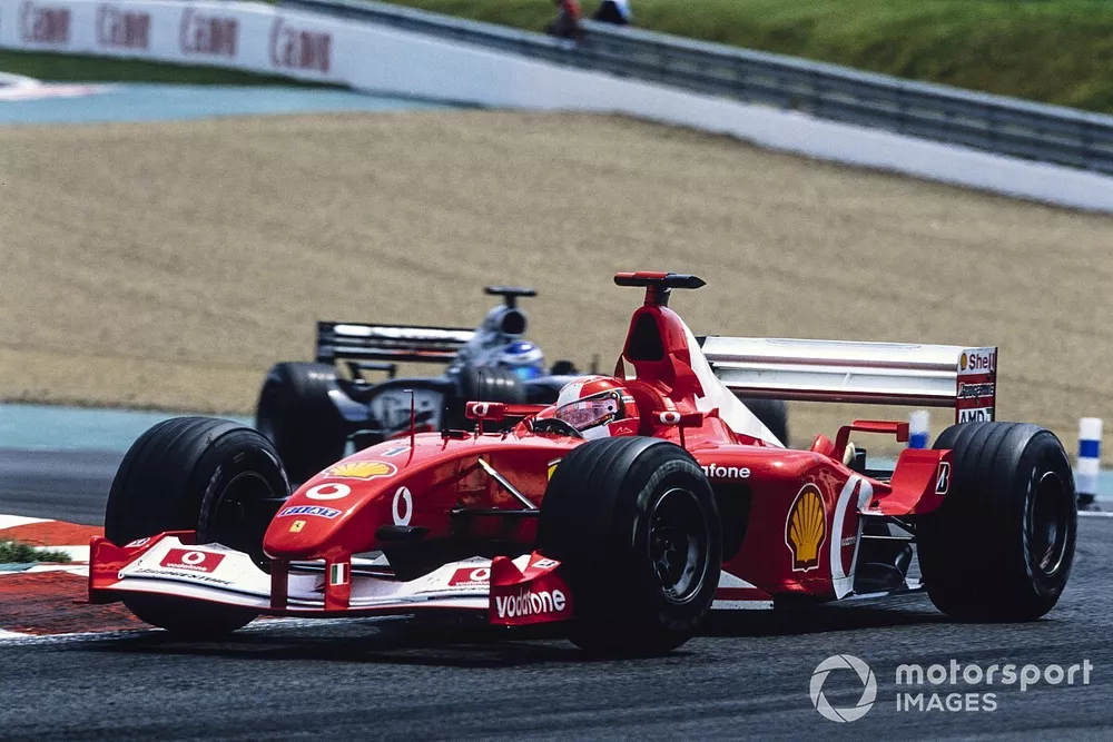 Michael Schumacher, Ferrari F2002, leads Kimi R&auml;ikk&ouml;nen, McLaren MP4-17 Mercedes.