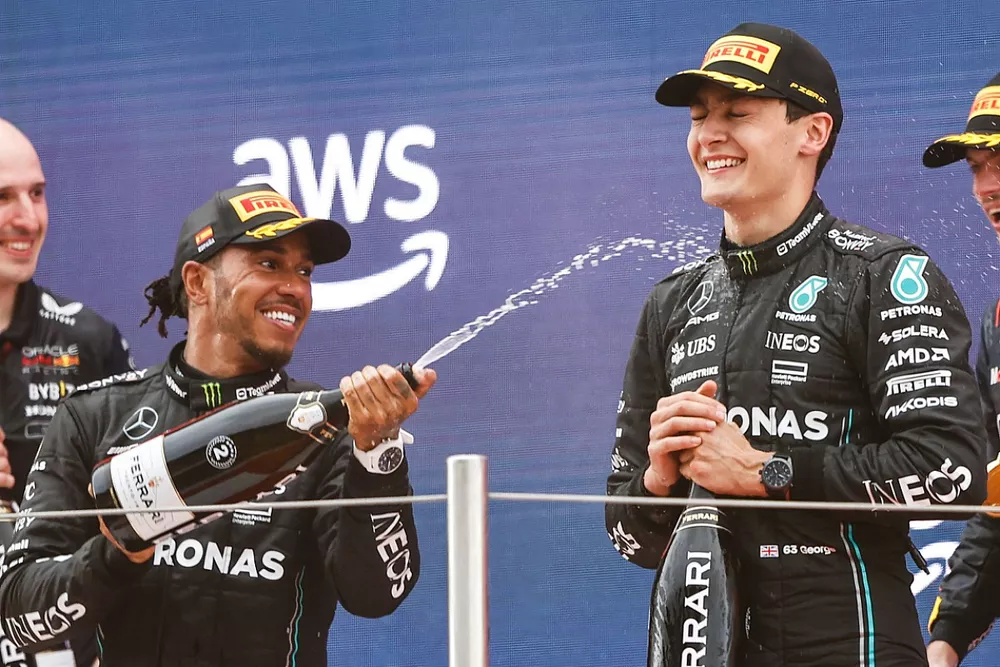 Lewis Hamilton, Mercedes-AMG, 2nd position, George Russell, Mercedes-AMG, 3rd position, Max Verstappen, Red Bull Racing, 1st position, celebrate on the podium with Champagne