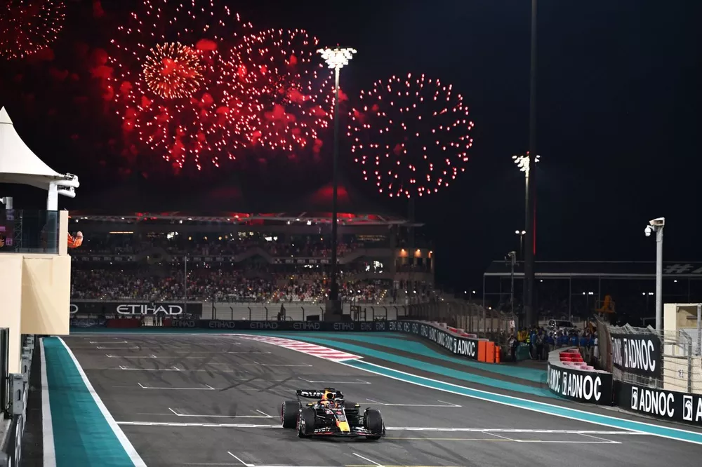 Max Verstappen, Red Bull Racing RB19, 1st position, crosses the line as fireworks light the sky