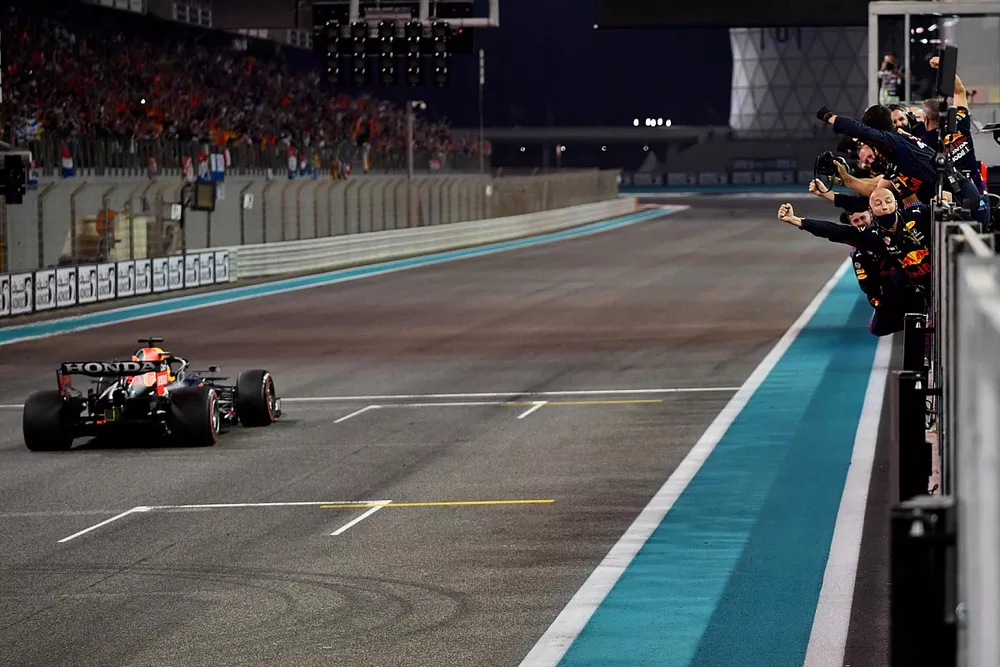 Max Verstappen, Red Bull Racing RB16B, 1st position, passes his cheering team on the pit wall