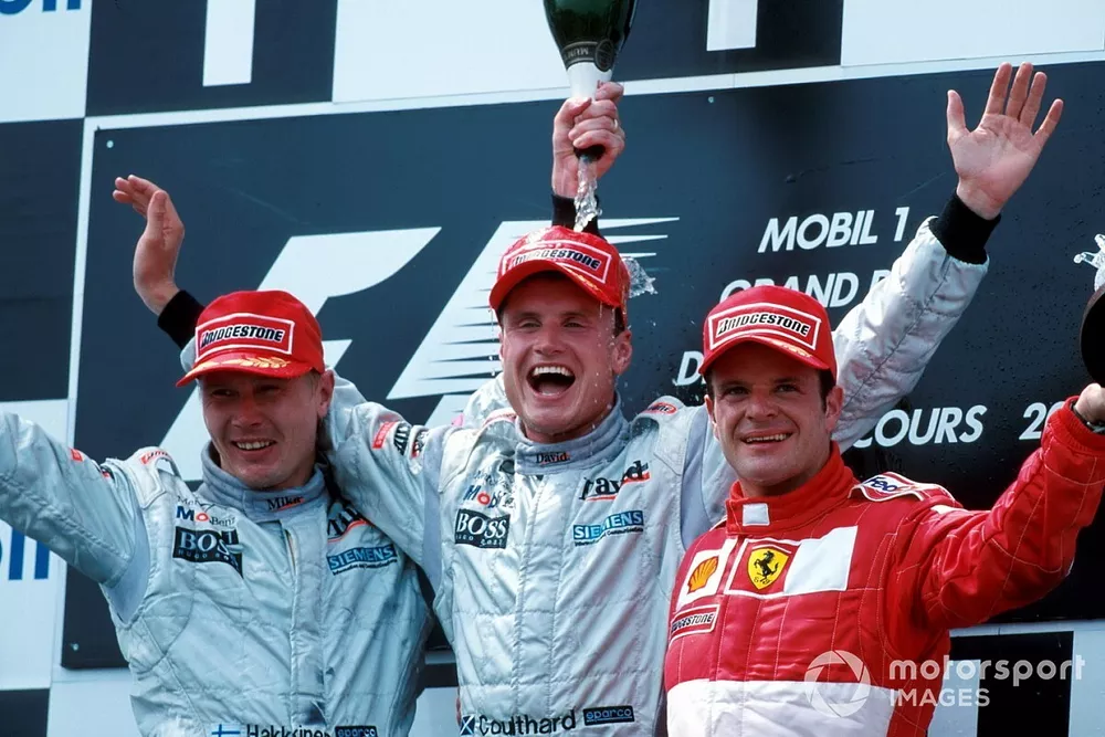 Podium: second place Mika Hakkinen, McLaren, race winner David Coulthard, McLaren, third place Rubens Barrichello, Ferrari