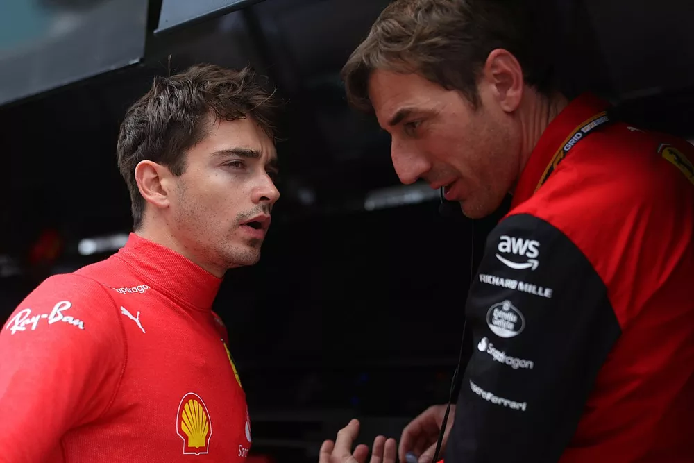 Charles Leclerc, Ferrari, with a team member on the pit wall