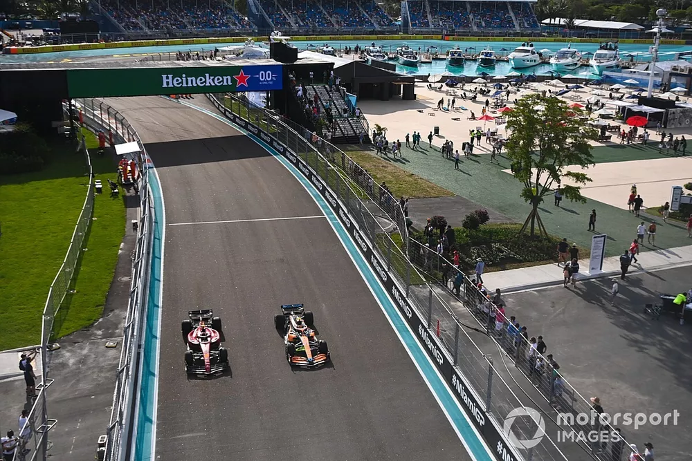 Lando Norris, McLaren MCL36, passes Carlos Sainz Jr., Ferrari F1-75