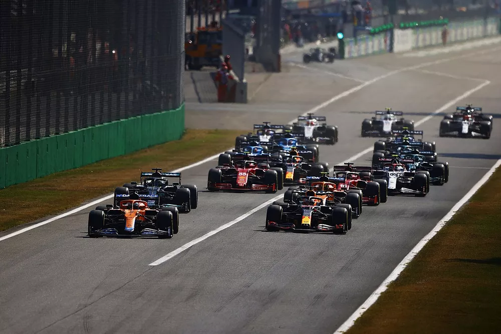 Daniel Ricciardo, McLaren MCL35M, Max Verstappen, Red Bull Racing RB16B, Lando Norris, McLaren MCL35M, Lewis Hamilton, Mercedes W12, Charles Leclerc, Ferrari SF21, and the rest of the field at the start