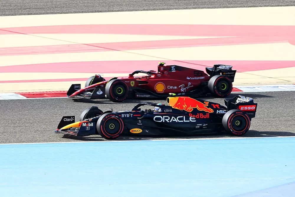 Sergio Perez, Red Bull Racing RB18, passes Carlos Sainz Jr., Ferrari F1-75