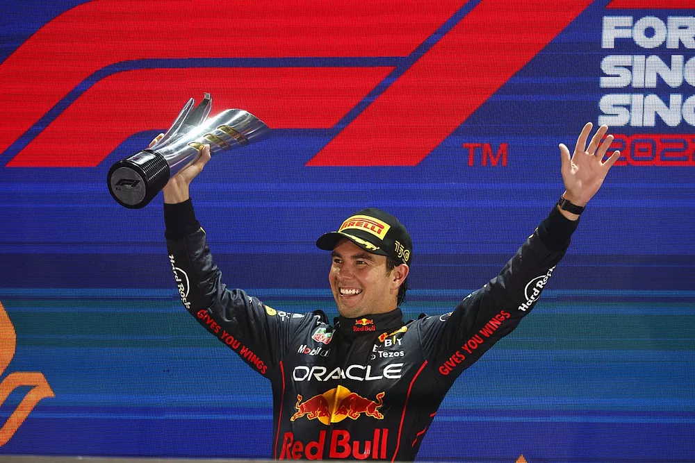 Sergio Perez, Red Bull Racing, 1st position, celebrates on the podium with his trophy