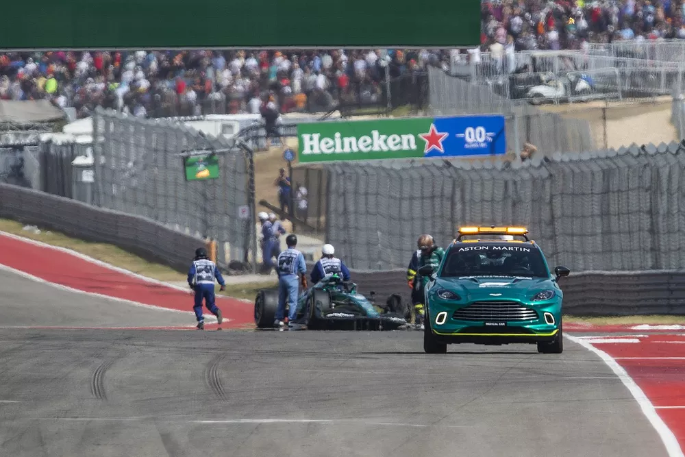 Marshals at the scene of the crash of Fernando Alonso, Alpine A522, and Lance Stroll, Aston Martin AMR22