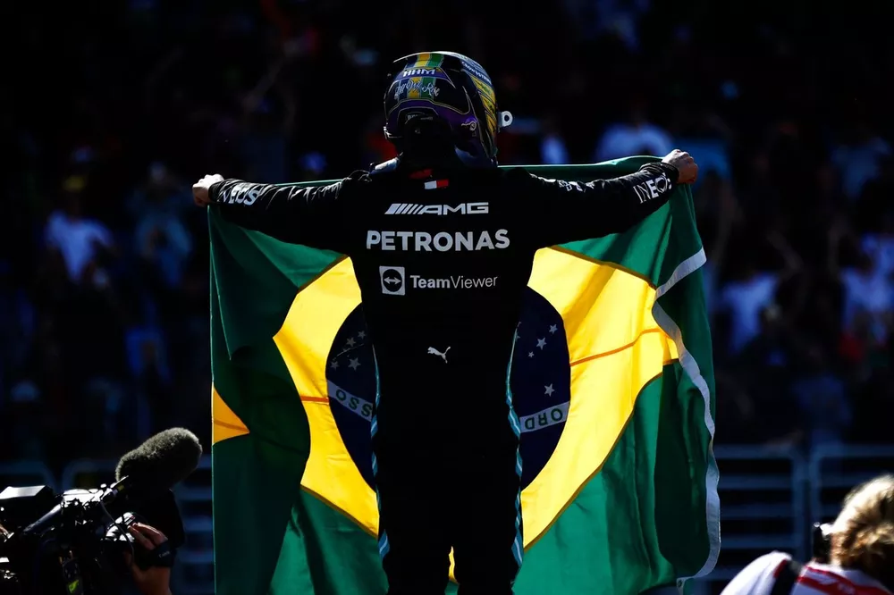 Lewis Hamilton, Mercedes, 1st position, celebrates with a Brazilian flag in Parc Ferme